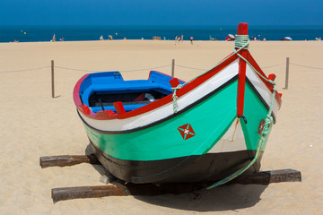 Naklejka na ściany i meble The fishing boat on the beach in Portugal