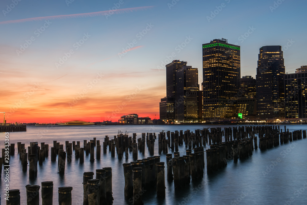 Aufkleber View of the night city. Glowing lights of skyscrapers. View of the city of New York and the bay. New York.   Long light exposure.
