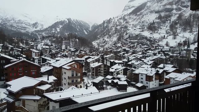 Zermatt view of the city with snowy mountains on a snowy day
