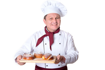 Chef confectioner holds on a tray fresh buns on a white background. Male cook.