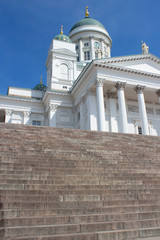 A granite staircase leads to the St. Nicholas Church to the main Helsinki Cathedral in Finland on a sunny summer day.