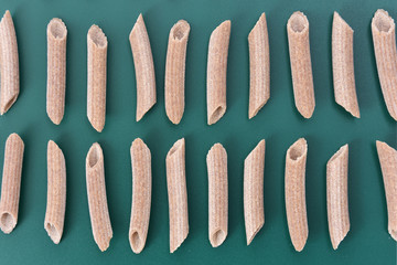 Buckwheat macaroni on green background