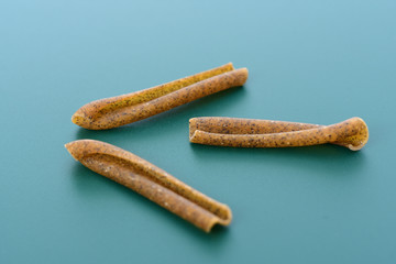 Pasta casarecce on green background