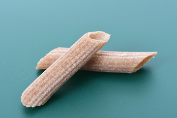 Pasta buckwheat macaroni  on green background