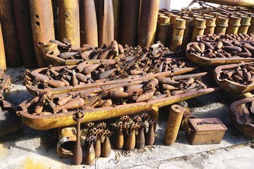 Rusted munitions, bomb housings and unexploded ordnance recovered and disarmed in rural Laos