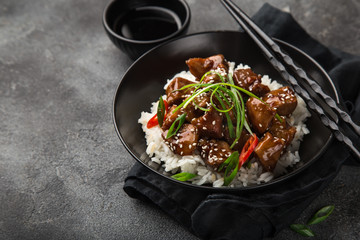 sweet sticky pork served with chives and  sesame seeds