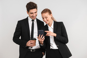 Confident young business couple standing