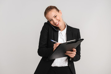 Smiling blonde business woman standing isolated