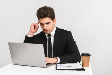 Concentrated young business man wearing suit