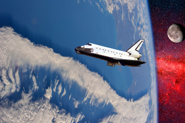 space ship shuttle on the earth orbit in atmosphere. flying in outer space. Elements of this image...