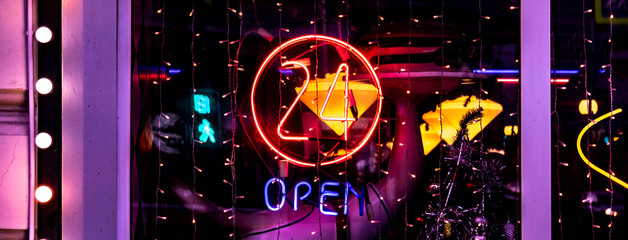 neon 24 hours open logo sign glowing in the bar store f