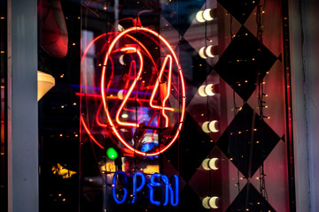 neon 24 hours open logo sign glowing in the bar store f