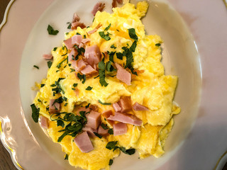 Scrambled eggs with ham. Breakfast.