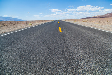 Death Valley road straight across the desert to the mountains in the distance