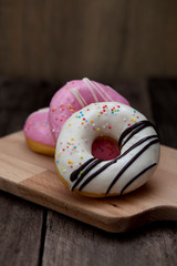 Glazed mini donuts on wooden background