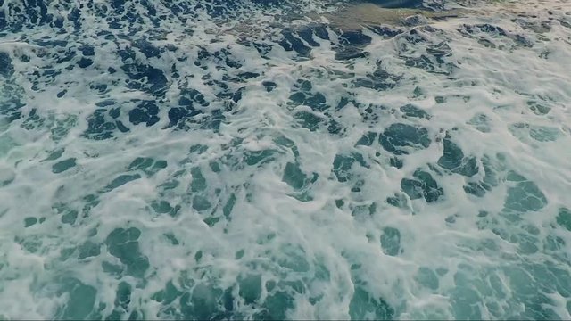 Sea waves in water filmed from above ferry 

