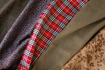 The texture of fabrics of different types. Fabrics with different textures create a background. Fabrics for sewing clothes and design.