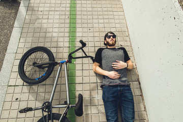 Young man with a bmx bike on the street.Rider BMX