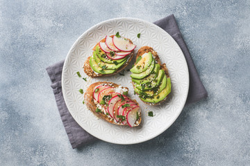 Cereal bread sandwiches with cottage cheese, fresh avocado and radish.