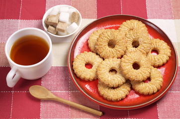 Tea in cup and sweet shortbread cookies