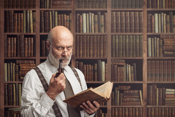 Academic professor in the library holding a book