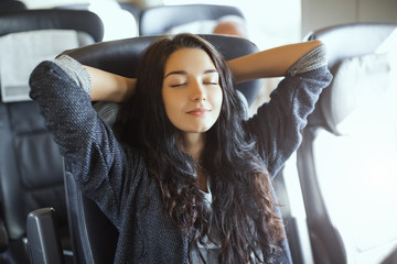 Young tourist woman traveling sitting in the train.