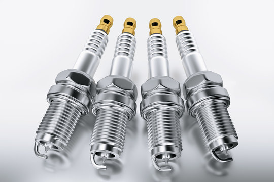 Spare parts spark plugs on white background for car and motorcycle. New auto parts spark plug.
