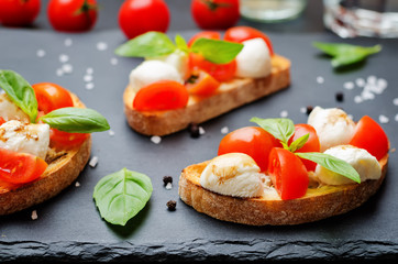 Caprese bruschetta with fresh tomatoes and Basil leaves
