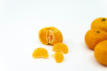 Small ripe mandarin orange isolated on white background.