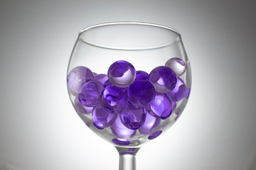 Violet hydrogel balls in a glass
