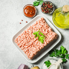 Minced meat, herbs, oil salt and pepper. Top view, space for text.