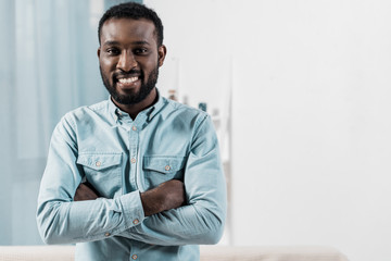 african american man looking at camera and smiling in living room