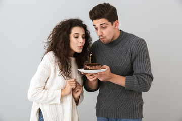 Cheerful couple wearing sweaters standing