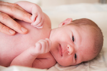 close-up portrait of a newborn baby holding father's finger