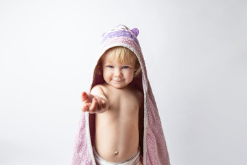 portrait of a little Caucasian baby girl in towel after a shower on a white background
