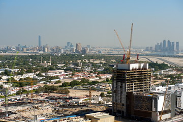 Aerial view of under construction building with cranes from downtown, visible whole Zabeel district, Dubai Creek harbor, Dubai Canal to Business Bay and Al Khail road