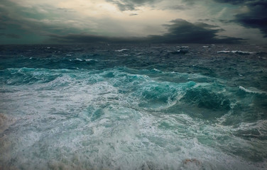 Fototapeta na wymiar Stormy sea view near coastline at evening time. Waves, splashed