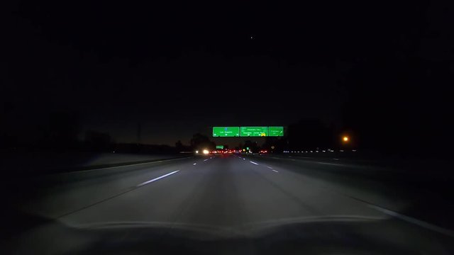 Night drive under Los Angeles 5 south freeway sign between Burbank and downtown LA in Southern California.  