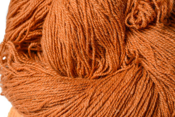 big skein of rough brown handmade sheep's wool. Made for knitting and crocheting,white isolated