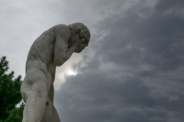 statue d'un homme se tenant le visage au jardin des tuileries Paris