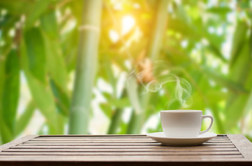 Coffee espresso on wood table nature background in garden,warm tone