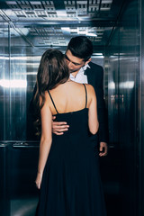 young couple passionately kissing and hugging in elevator