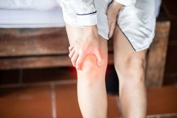 woman have a kneecap pain sitting on bed in bedroom after wake up feeling so illness,Healthcare concept