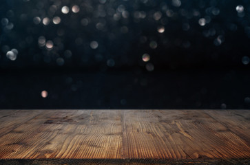 Dark bokeh background with wooden table