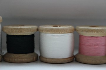 spool of thread textiles material clothing fabric soft background macro texture old black black pink small tree three erased gray background necessary stationery tailor profession