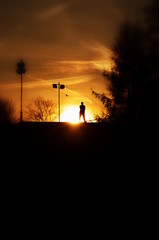 Photograph of a silhouette looking at the sunset