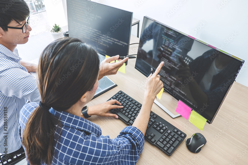 Aufkleber Two professional programmers cooperating at Developing programming and website working in a software develop company office, writing codes and typing data code