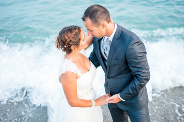 Bride and groom in romentic scenery by the ocean