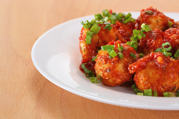 Meatballs in tomato sauce served on a plate.