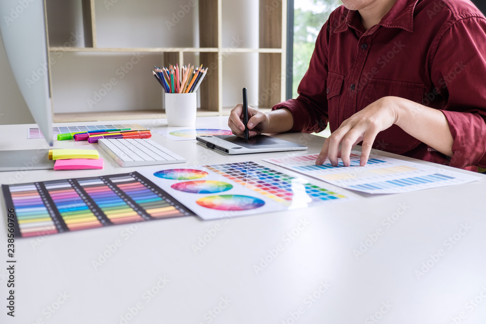 Aufkleber image of female creative graphic designer working on color selection and drawing on graphics tablet 